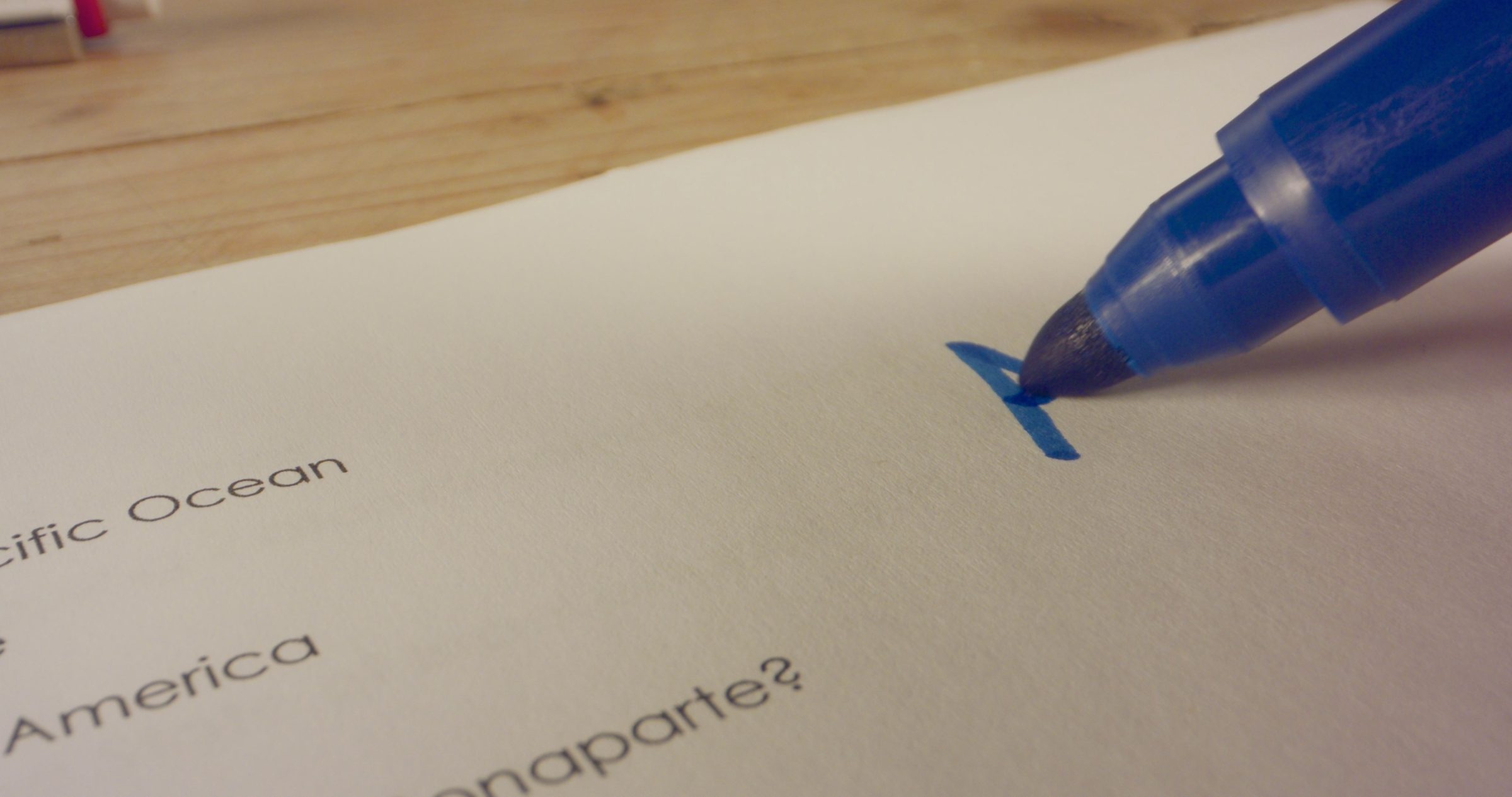 A hand marking a score on a paper