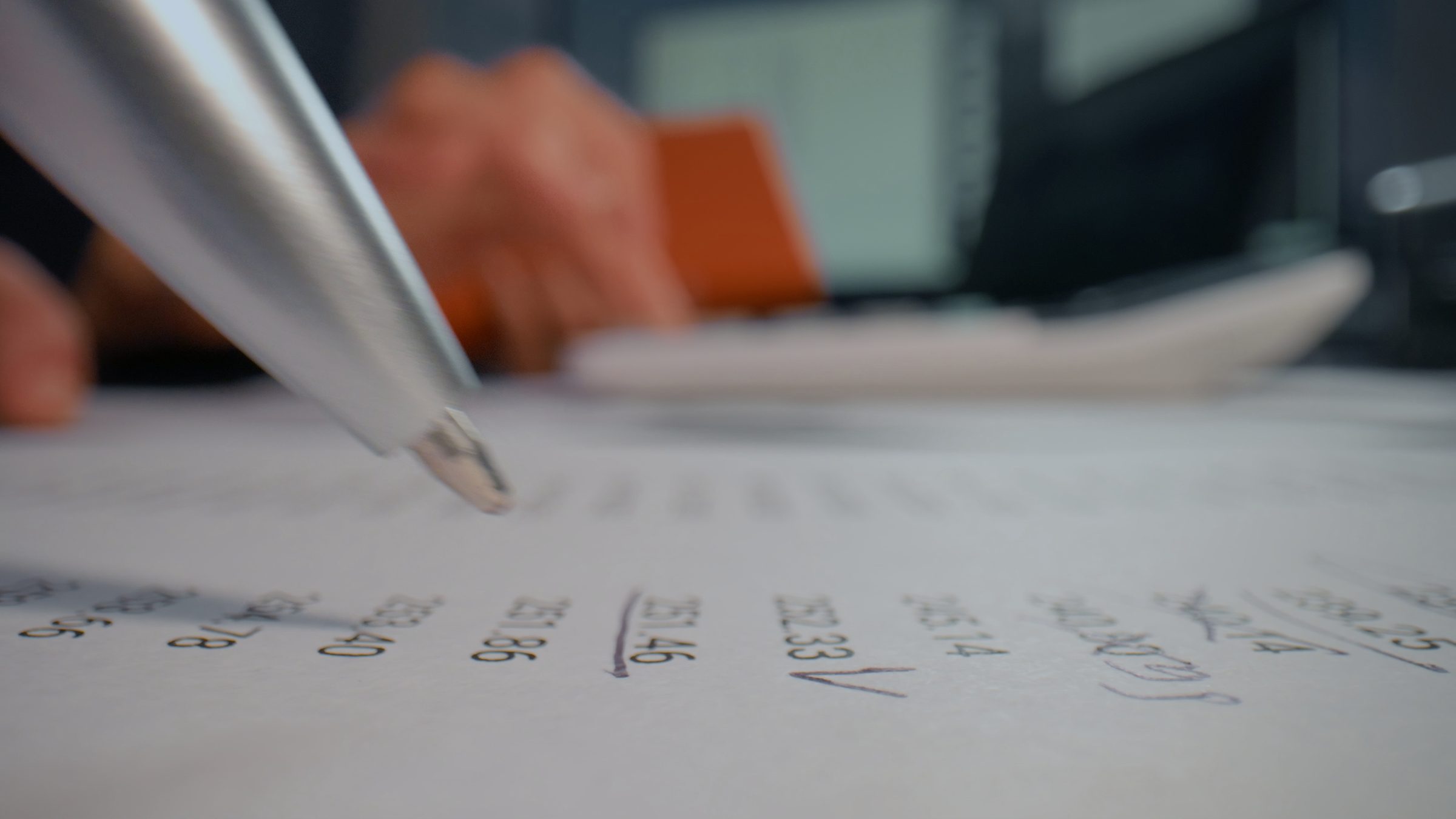 A pen resting on a financial ledger